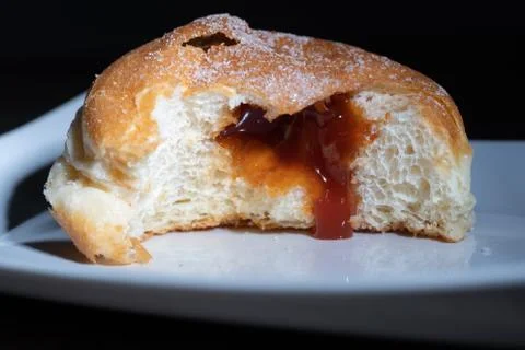 Close-up of a doughnut filled with jam Stock Photos