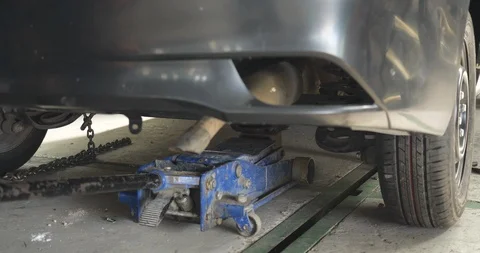 Close-up, down car on lift in auto body repair shop Stock Footage 114218795