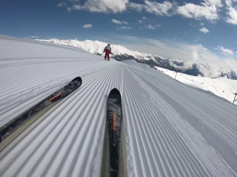 Close-up downhill skis quickly glide down a squandered ski slope Stock Footage 161752726