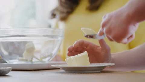 Close Up Of  Downs Syndrome Couple Adding Butter To Cake Recipe They Are Baking Stock Footage 114303531