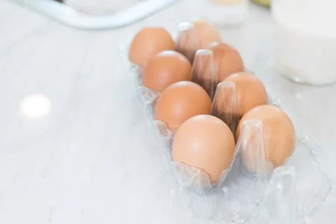 Close up of dozen of eggs on white table for prepare cooking in kitchen. Dess Stock-Fotos