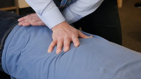 Close up of Dr working on patients lower back Video stock 107758539