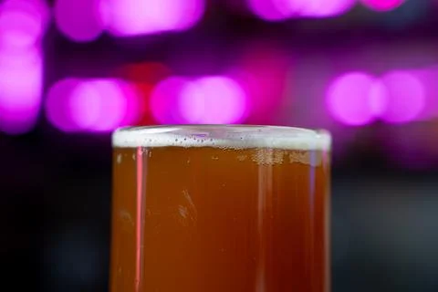 Close up of draft beer with neon light background Stock Photos