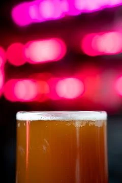 Close up of draft beer with neon light background Stock Photos