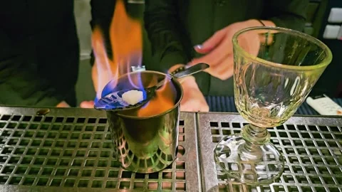 Close-up of a dramatic cocktail being prepared with blue fire at a bar, showing Stock Footage 339847078