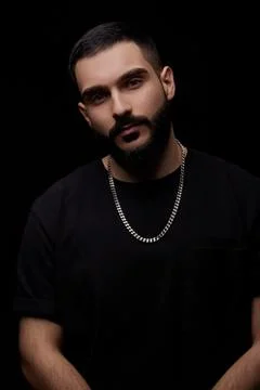 A close-up dramatic portrait of a young serious guy, musician, singer,rapper  Stock Photos