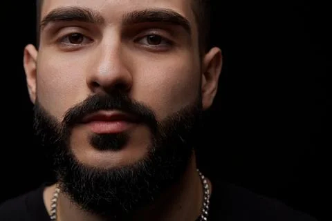 A close-up dramatic portrait of a young serious guy, musician, singer,rapper  Stock Photos