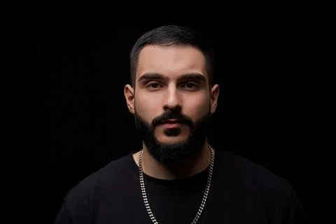 A close-up dramatic portrait of a young serious guy, musician, singer,rapper  Stock Photos
