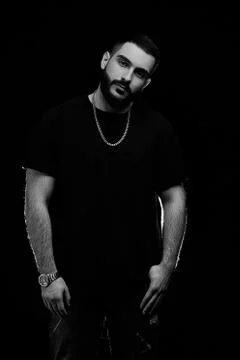 Close-up of a dramatic portrait of a young serious guy, musician, singer, rap Stock Photos