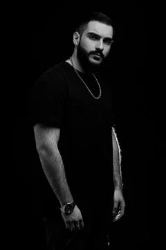 Close-up of a dramatic portrait of a young serious guy, musician, singer, rap Stock Photos