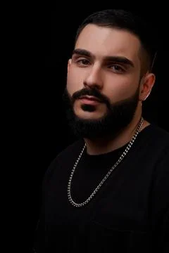 Close-up of a dramatic portrait of a young serious guy, musician, singer, rap Stock Photos