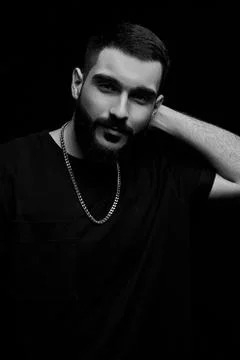 Close-up of a dramatic portrait of a young serious guy, musician, singer, rap Stock Photos