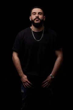 Close-up of a dramatic portrait of a young serious guy, musician, singer, rap Stock Photos