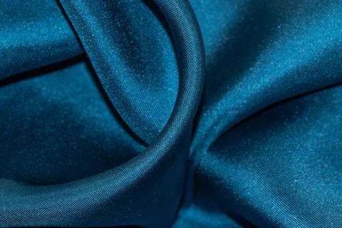 Close up of draped textile material in dark sea wave color. Stock Photos