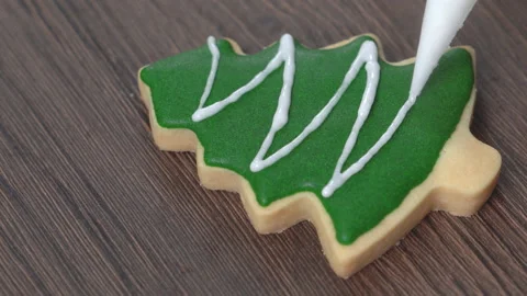 Close up of drawing Christmas tree sugar cookie on wooden table background wi Stock Footage 144318678