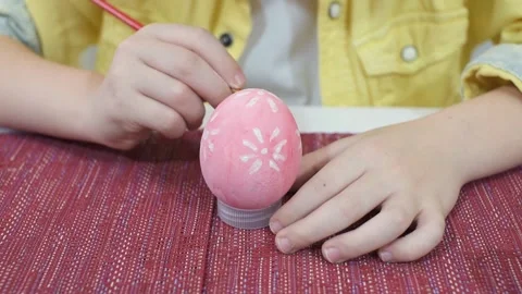 Close-up, drawing an Easter pattern on a pink egg Stock Footage 150056344