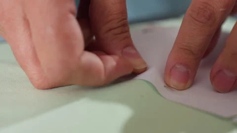 Close Up Dress Maker Securing Pattern on Elastic Light Green Textile Stock Footage 307136497