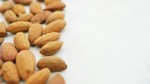 Close-up dried almonds on white grey background Stock Photos