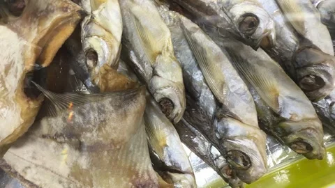 Close-up of dried crucian fish, roach and other fish lying on the counter in a Stock Footage 271231041