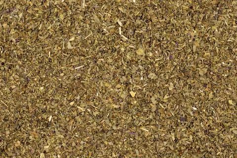 Close-up Dried crushed basil background. Dried ground basil powder spices. Sp Stock Photos