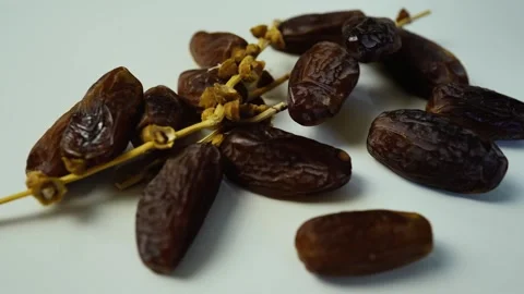 Close-up of Dried Dates on Branch, Close-up of dried dates on a white backg.. Stock Footage 304974205