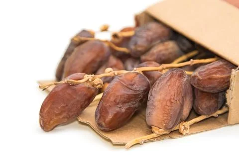 Close up of dried dates in paper box  on white background Stock Photos