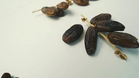 Close-up of Dried Dates on Stem, Close-up of dried dates on a light surface.. Stock Footage 304974809