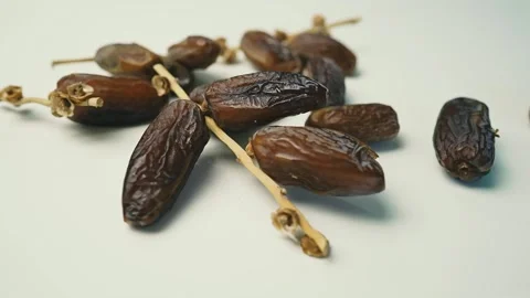 Close-Up of Dried Dates on Stems Footage, Close-up of dried dates on a whit.. Stock Footage 304974619