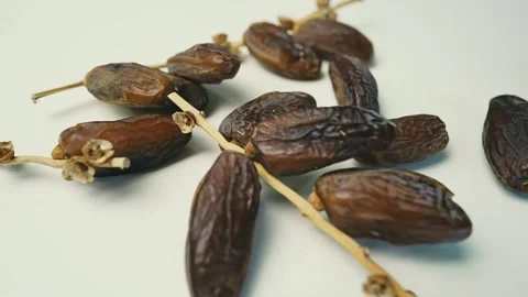 Close-Up of Dried Dates on Stems Footage, Close-up of dried dates on a whit.. Stock Footage 304974685