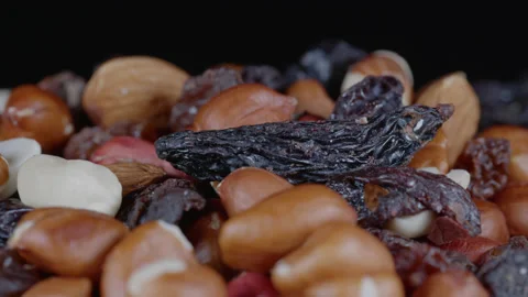 Close up of dried fruit and nuts slowly rotating - black background. 4K  tripod Stock Footage 169121116