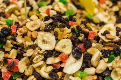 Close up of dried fruit and nuts mix with banana, raisins, and candied fruit. Stock Photos