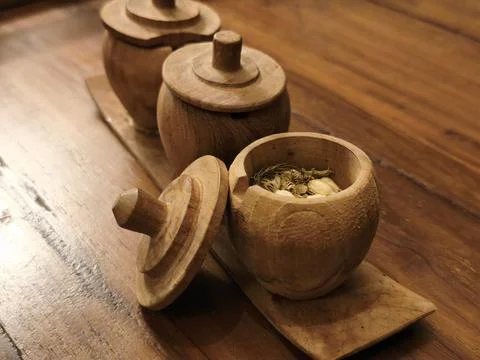 Close up of dried jasmine tea inside a turned wooden jar 写真素材