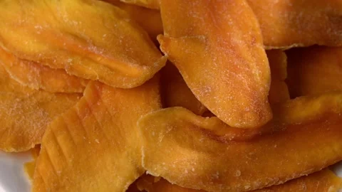Close-up of dried mango strip rotating, flexible and sticky texture Stock Footage 326816223