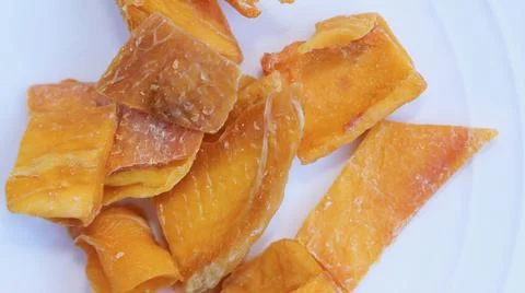 Close up of dried orange mango on plain white background Stock Photos