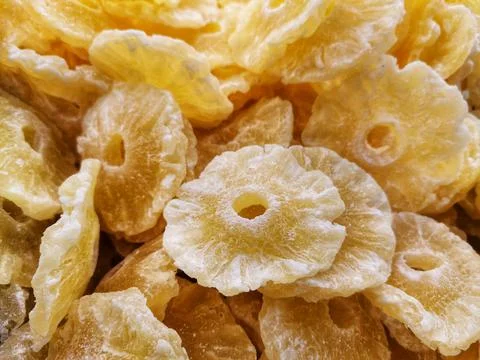 Close-up dried pineapple fruit. Background of dry pineapple and detail shots. Stock Photos