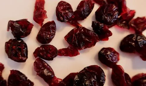 Close up of dried red cranberries on plain white background Stock Photos