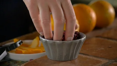 A close-up of dried rose petals dropping in a cup at a bar. Stock Footage 113693443
