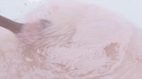 Close Up Of Dried Yeast Granules Being Stirred Into Water, UK 動画素材 138346568