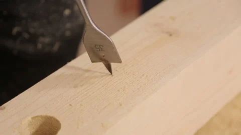 Close up drill bit boring a hole in wooden desk Stock Footage 95527553