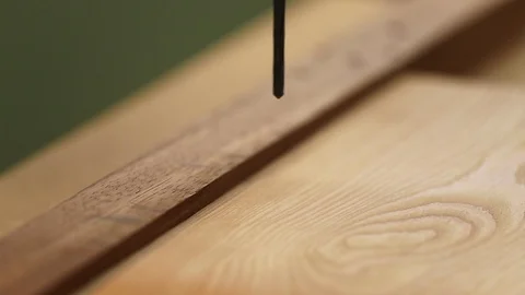 Close up of a drill bit drilling a hole in a piece of wood using a pillar Video stock 99741417