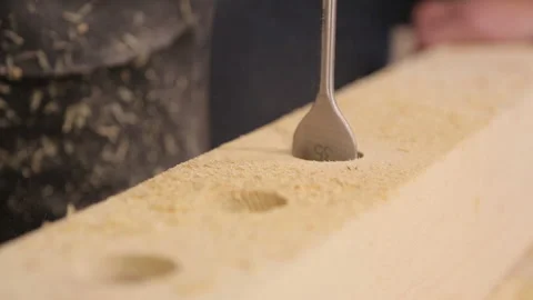 Close up drill bit drilling holes in wooden bar Stock Footage 95527585