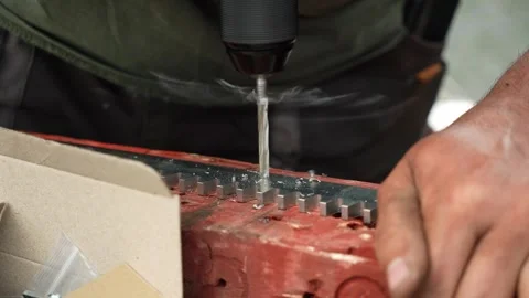 Close up of Drill bit Drilling into metal Pipe Stock-Footage 258645996
