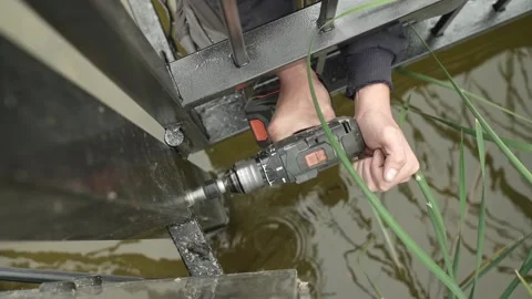 Close up of Drill bit Drilling into metal Pipe. Drilling a hole in the pipe Stock Footage 259037679