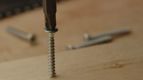 Close up of drill bit of electronic screwdriver being placed in screw and Stock Footage 261129150