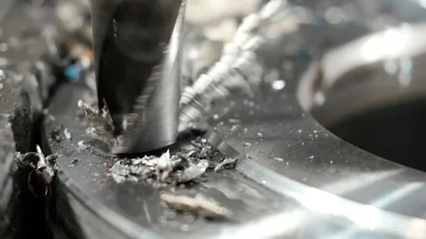 Close-up of a drill bit making a hole in a metal workpiece. Stock Footage 306541509