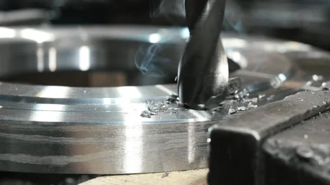 Close-up of a drill bit making a hole in a metal workpiece. Stock Footage 306541931