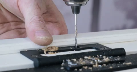 Close-up Drill. Master Drills Holes in Wooden Board. Fasteners Door Hinges Stock Footage 134332532