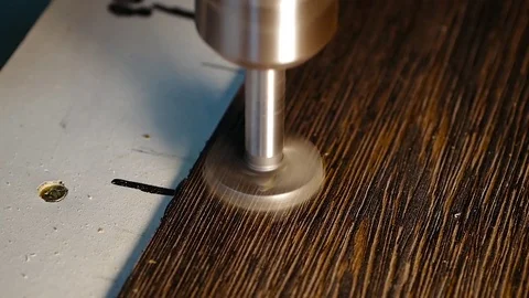 Close-up a drill press with a drill bit mounted in the chuck to drill Stock Footage 85370294