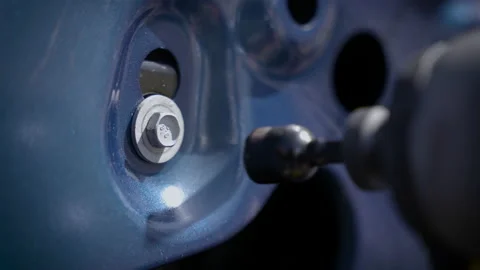 Close-up of drill unscrewing screw from car door. Video stock 220181348