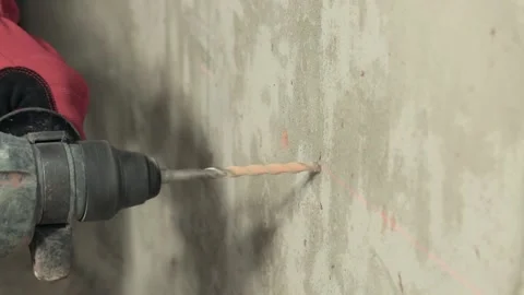 Close-up drilling a hole in a concrete wall Stock Footage 147538575